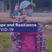 resilience and hope are keys to survival during COVID-19. hoto of woman in Nicaragua wearing a mask and walking with her son who is also wearing a mask. Text says 