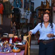 COVID-19 accelerates digitalization in low-income countries. In this photo, a small business owner in Latin America stands in her shop.