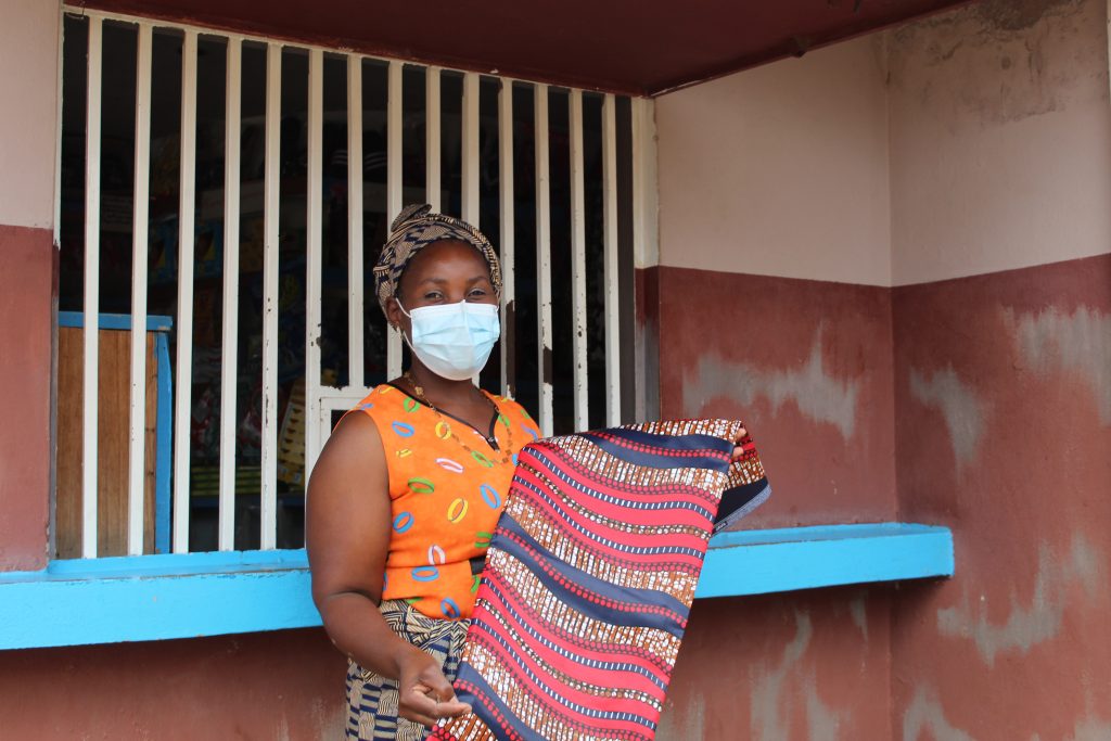 Leila shows off one of the new capulanas, a traditional sarong, she now sells.