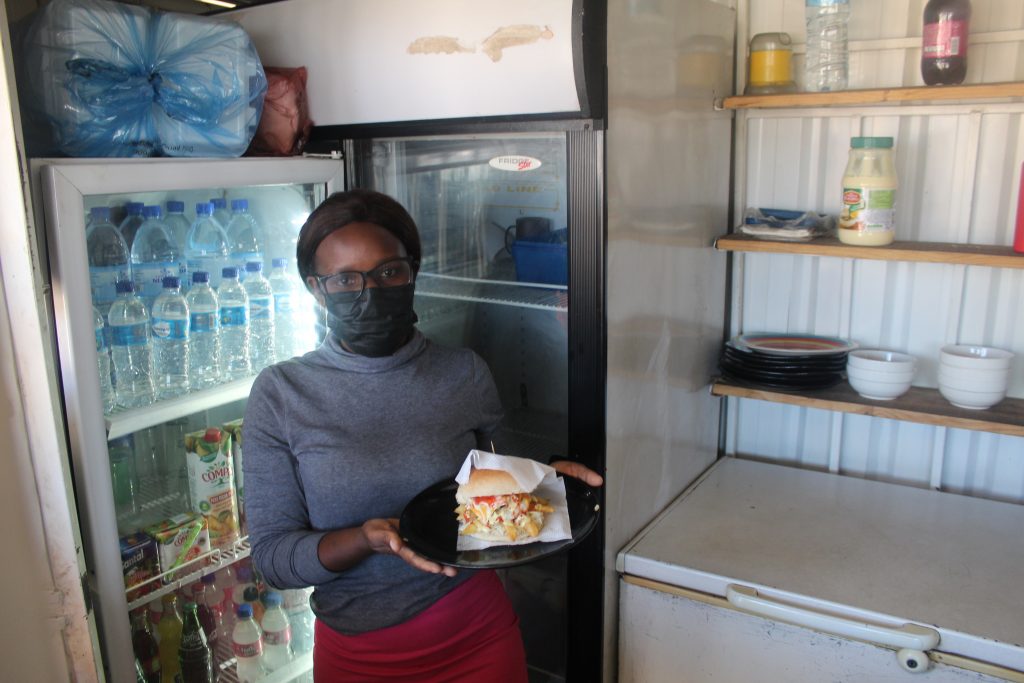 Chef and small business owner Mónica Momade in her takeout shop with a meal she cooked.