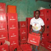 woman entrepreneur in Cote d'Ivoire working in her warehouse and smiling at the camera