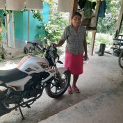 Maria Rosales with her motorcycle in Honduras