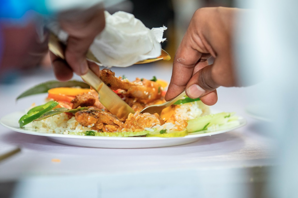 A cashew-based dish with rice created during the cooking competition at the event.