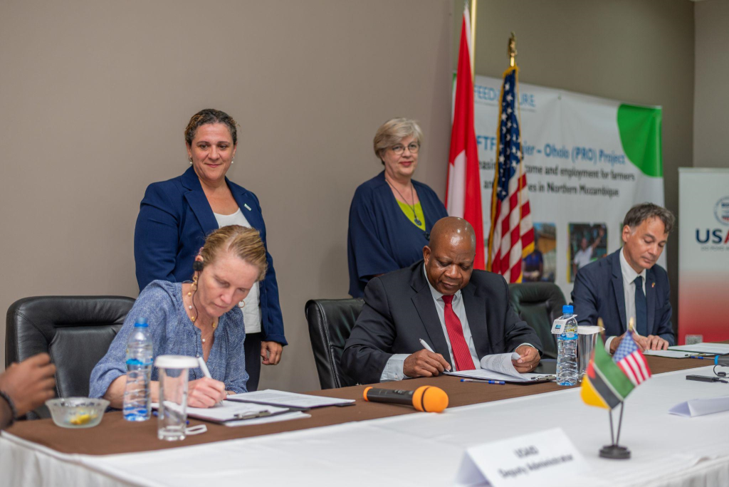 Representatives of the US, Swiss, and Mozambican governments sign an MOU