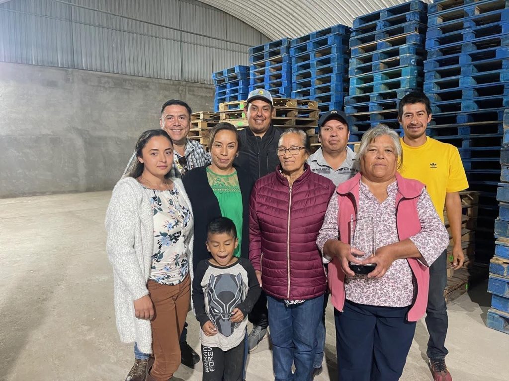 A few members of a tomato agribusiness stand in their warehouse in Mexico.