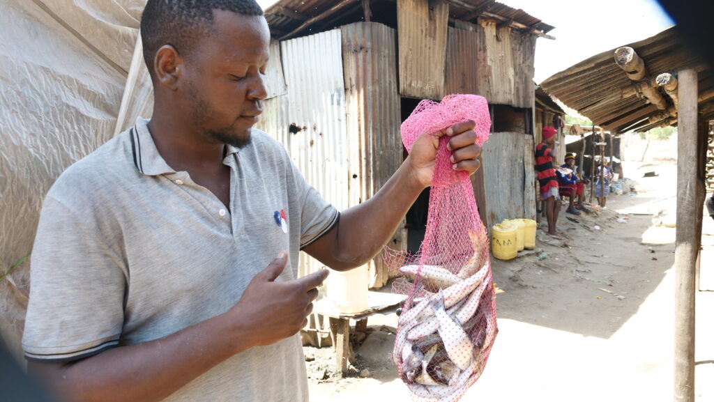 Brian Mwakudza shows off his recent catch in Mombasa County, Kenya. (TechnoServe)