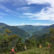 Farmers walk across a landscape in Colombia
