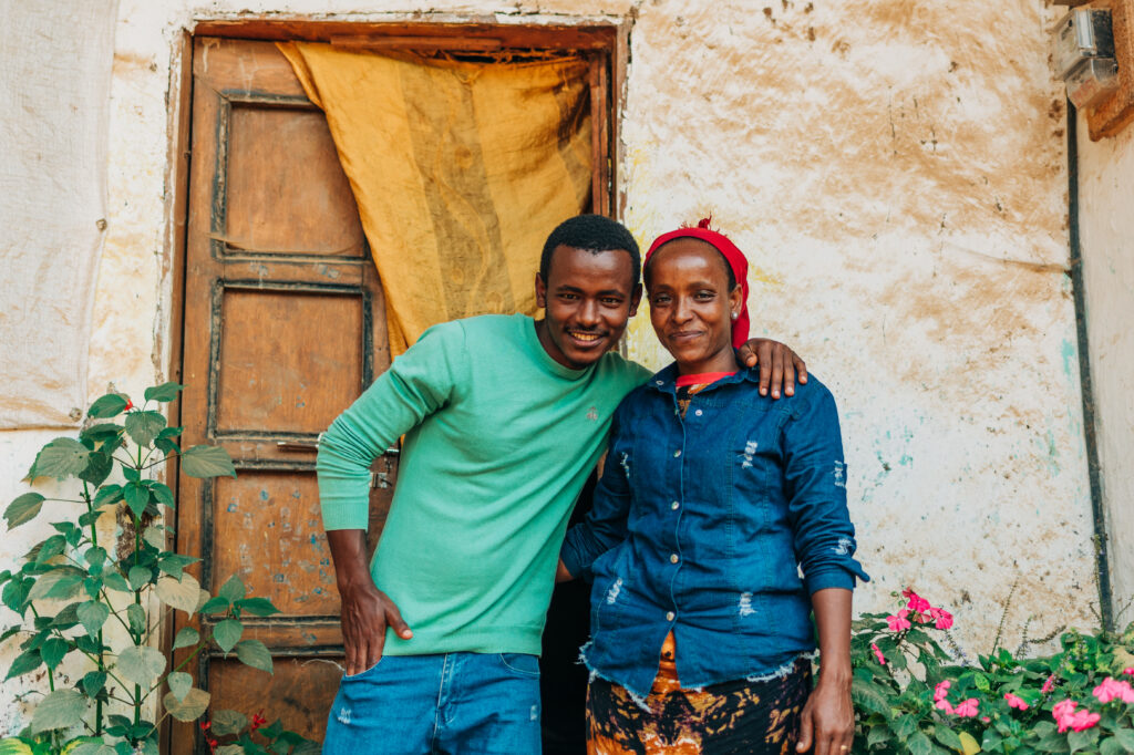 Lubaba Mekonnen (right) and her son, Mohammed Jamal, outside their house in Ethiopia’s Jimma zone. (TechnoServe / Olivia Sakai)