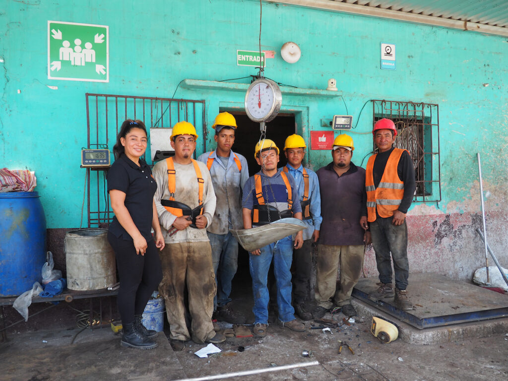 The of La Vaquerita in Apopa, El Salvador standing front of their recycling business