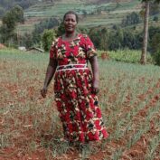 A woman stands in her field of onions in eastern Uganda. Part of a blog post on regenerative agriculture.