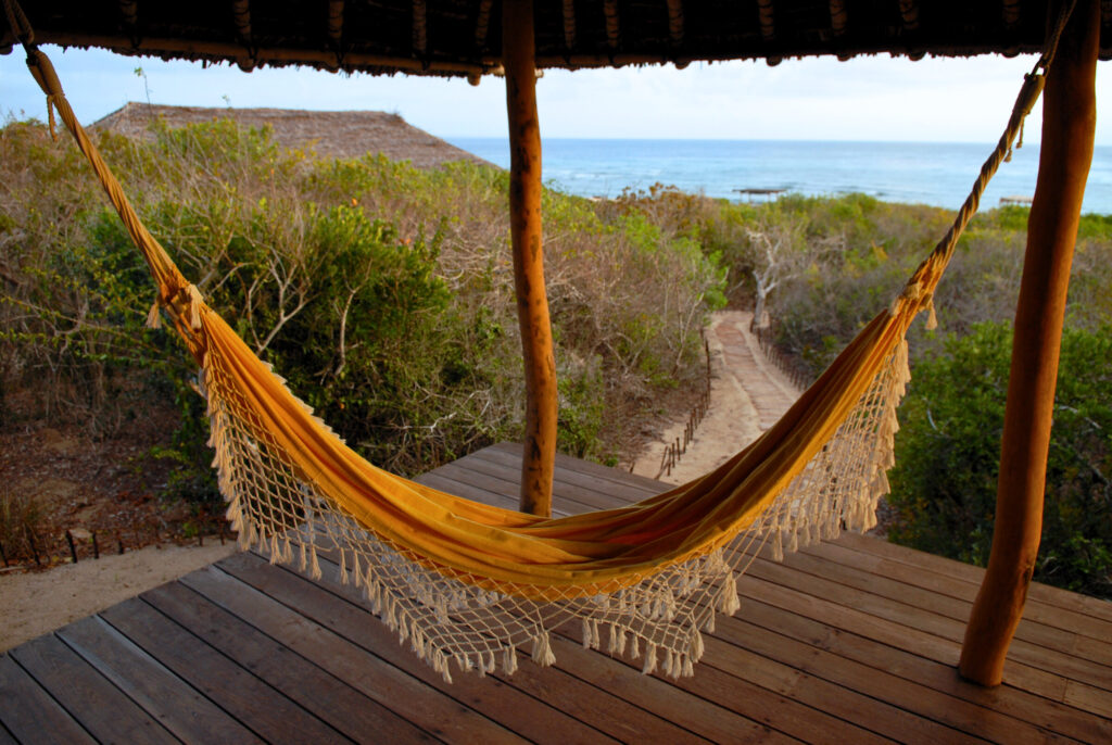 The ocean is visible behind an empty yellow hammock in an ecotourism lodge in Mozambique. Ecotourism is fast-growing sector of the blue economy. TechnoServe works with entrepreneurs to build successful blue businesses.    