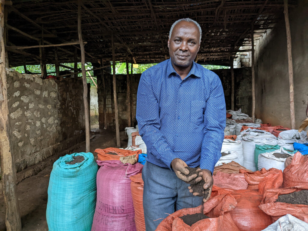 Farmer Bogale Borana displays compost from his farm in Ethiopia