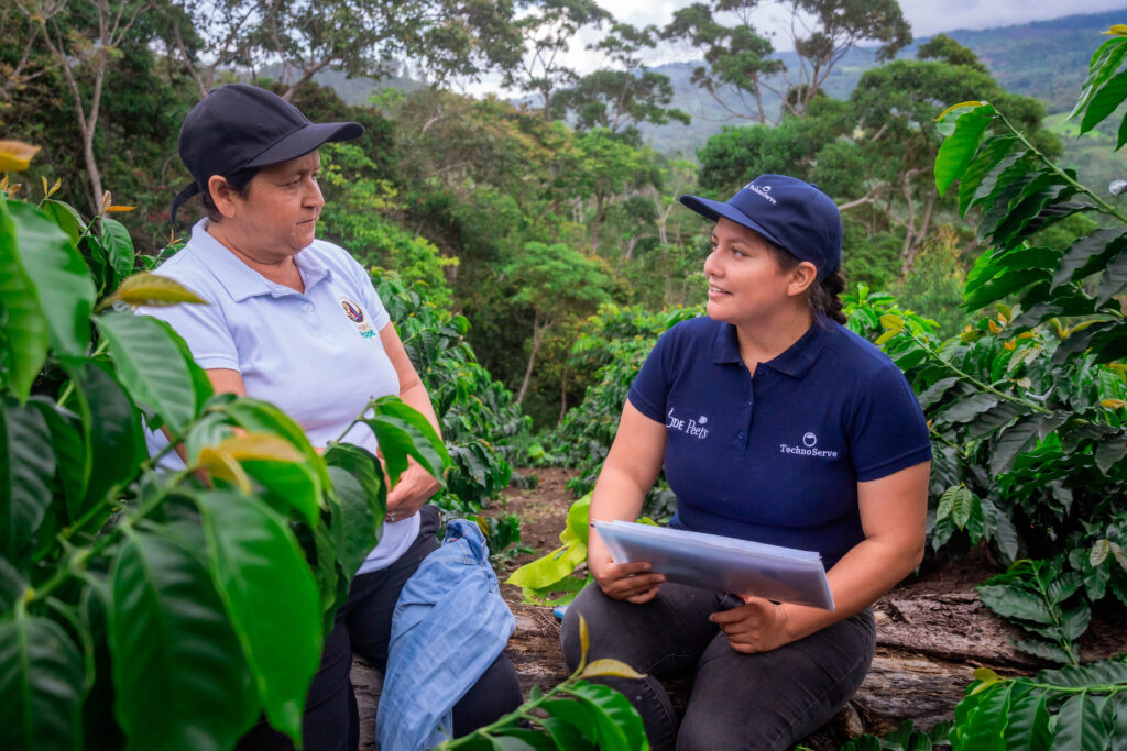Two women standing in a coffee field in San Martin, Peru. 