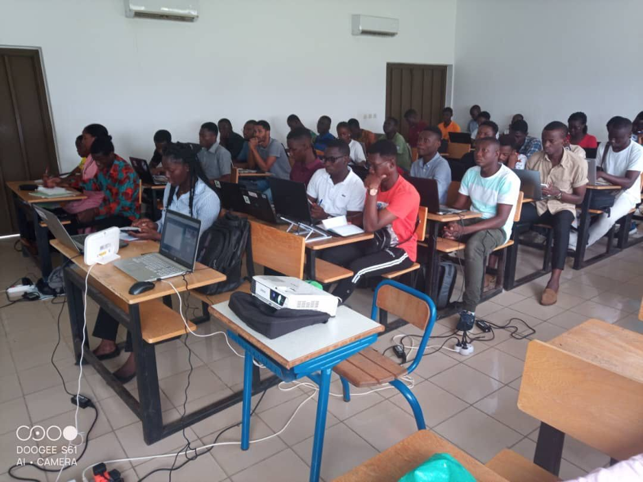 A classroom of young people sitting and using their laptops.